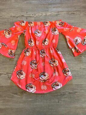 Salmon color floral off-the-shoulder mini dress with bell sleeves and tie waist.
